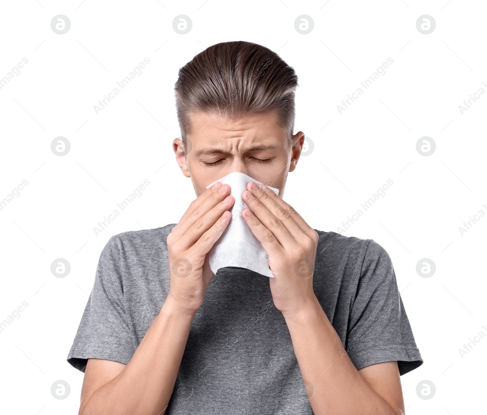 Photo of Young man with tissue suffering from sinusitis on white background