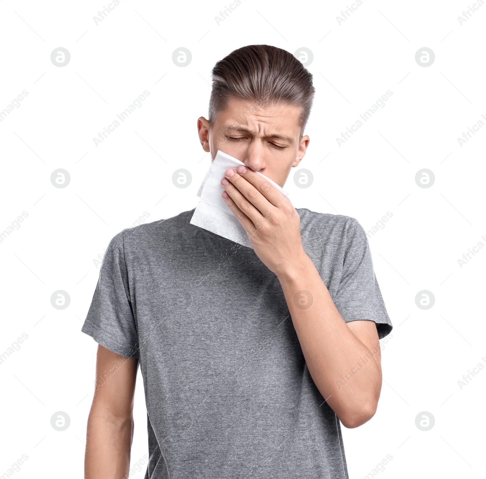 Photo of Young man with tissue suffering from sinusitis on white background