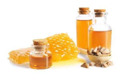 Photo of Natural honey tincture, propolis granules and sweet honeycombs isolated on white