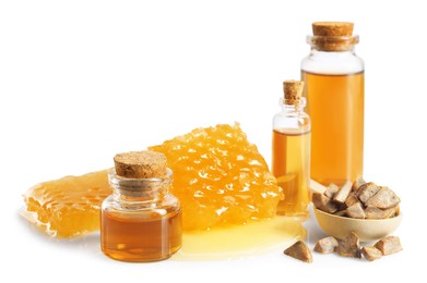 Photo of Natural honey tincture, propolis granules and sweet honeycomb isolated on white