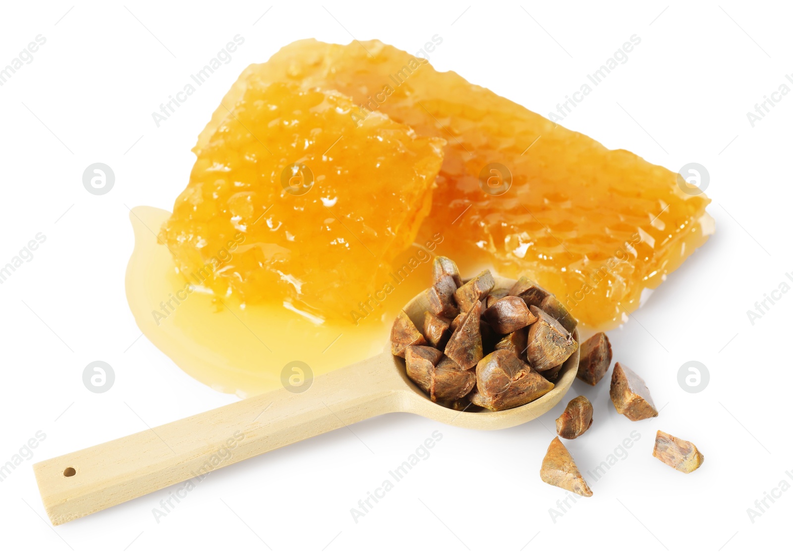 Photo of Sweet honeycombs and spoon with propolis granules isolated on white