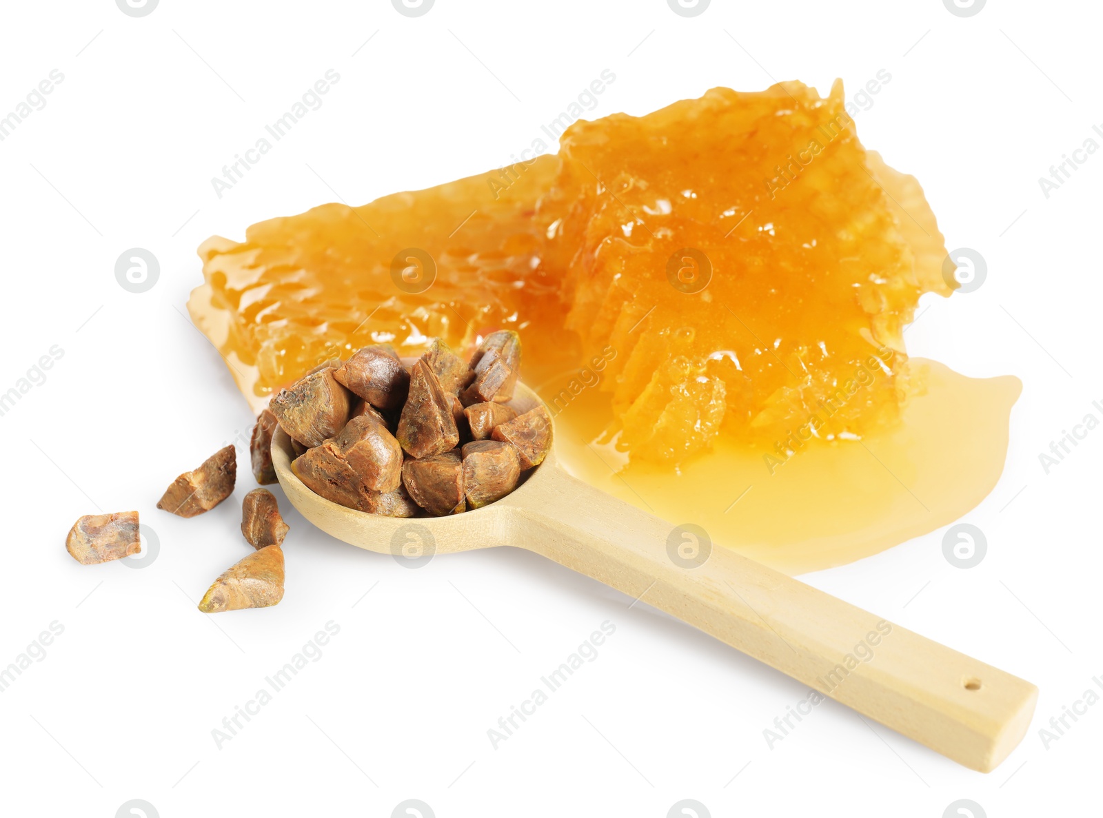 Photo of Sweet honeycombs and spoon with propolis granules isolated on white