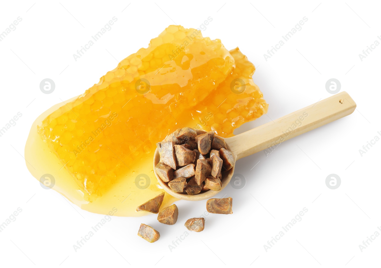 Photo of Sweet honeycombs and spoon with propolis granules isolated on white