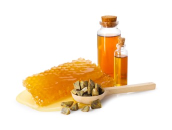 Photo of Natural honey tincture, propolis granules and sweet honeycombs isolated on white