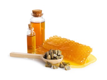 Photo of Natural honey tincture, propolis granules and sweet honeycombs isolated on white