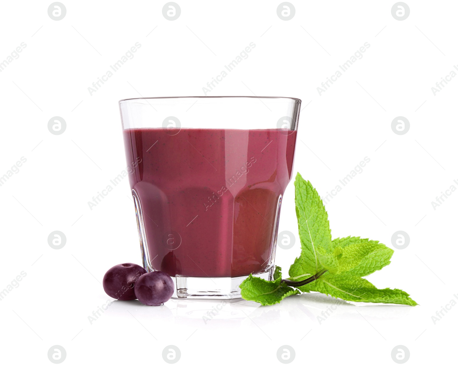 Photo of Tasty acai juice in glass, mint and berries isolated on white