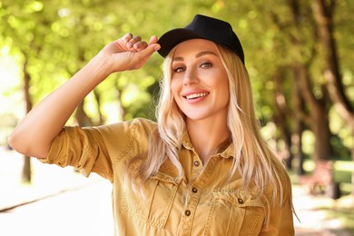 Portrait of smiling woman in baseball cap outdoors