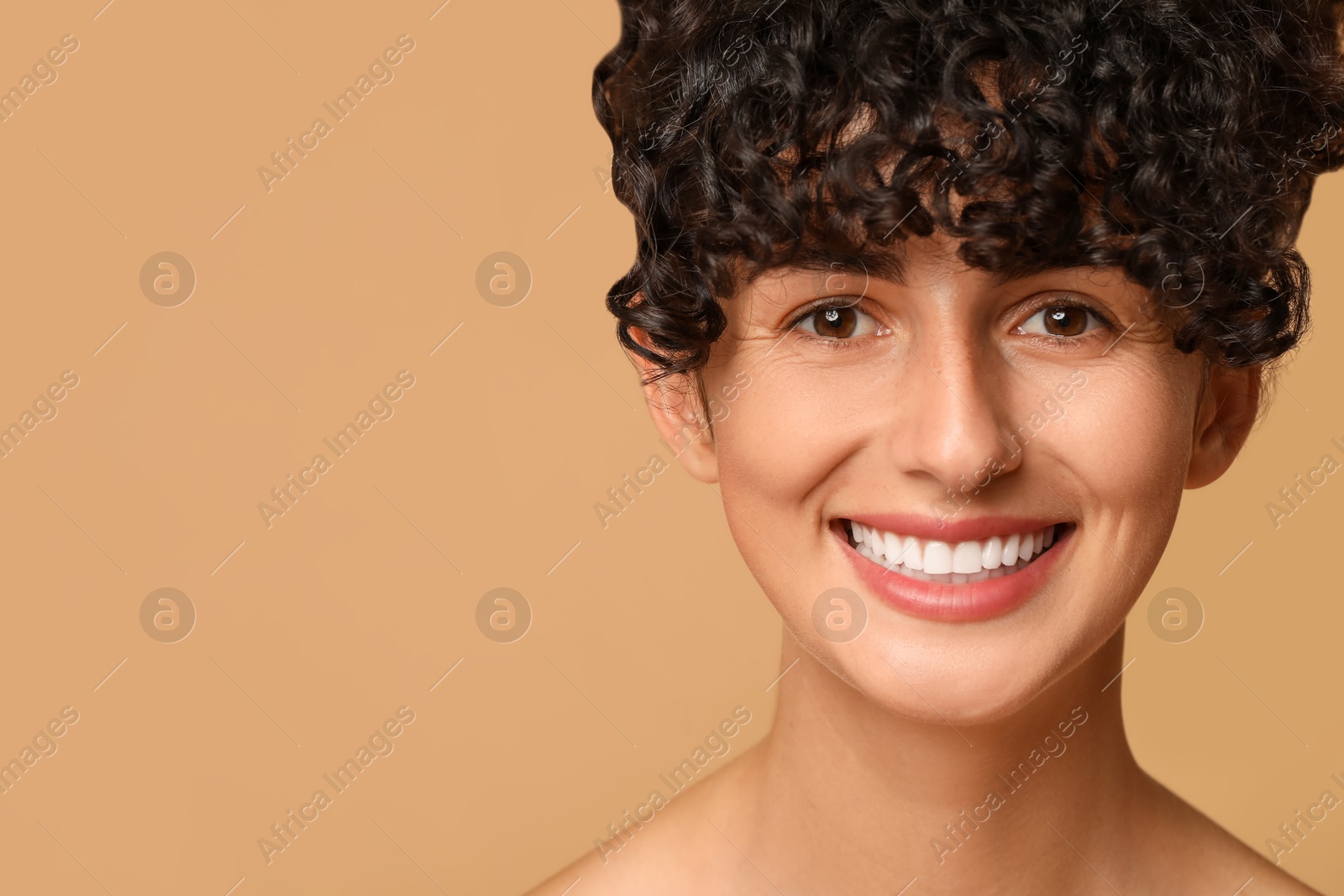 Photo of Happy young woman on beige background, space for text. Dental veneers