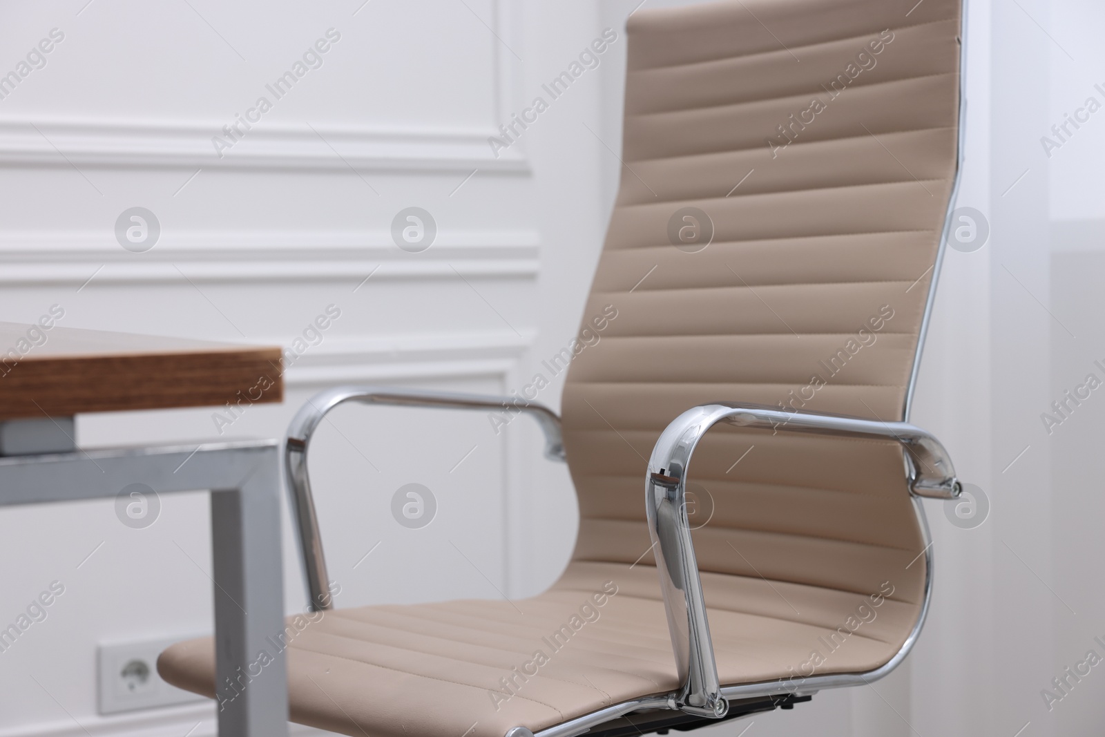 Photo of Beige leather chair and desk in office