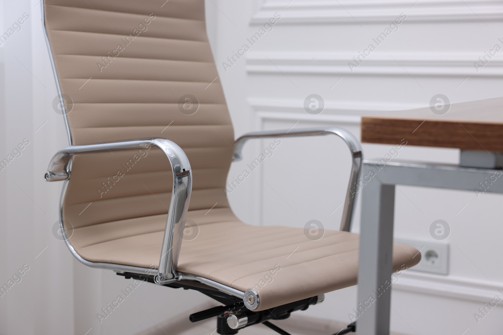 Photo of Beige leather chair and desk in office