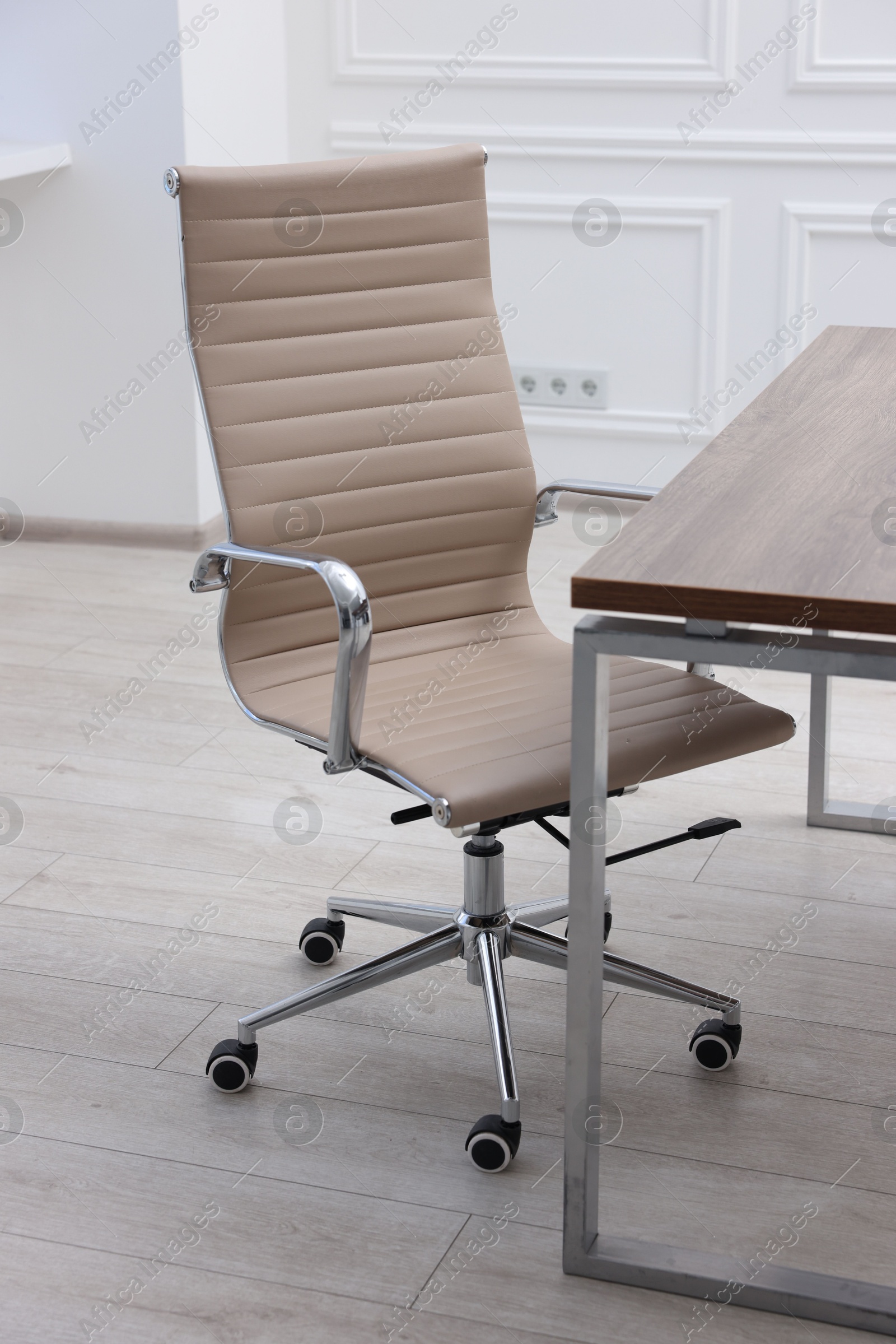 Photo of Beige leather chair and desk in office