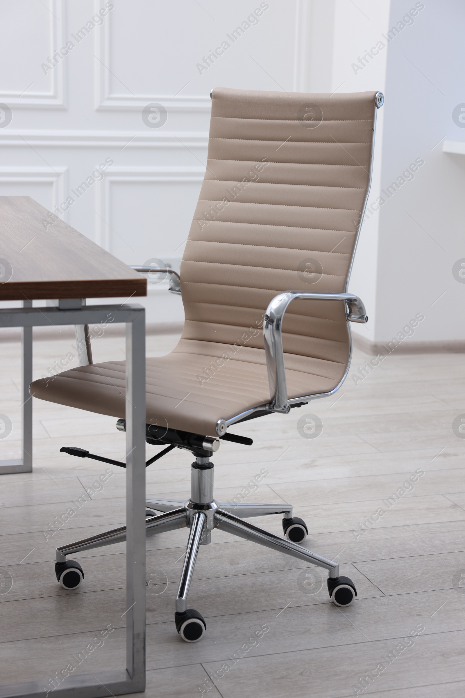 Photo of Beige leather chair and desk in office