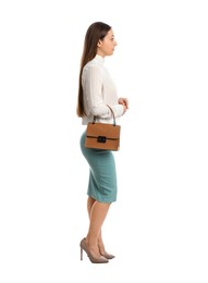 Young woman in business attire with bag on white background