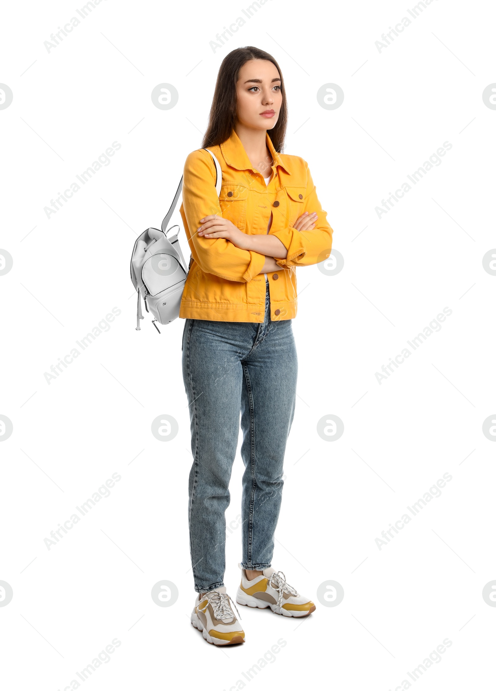 Photo of Young woman in casual clothes with backpack on white background