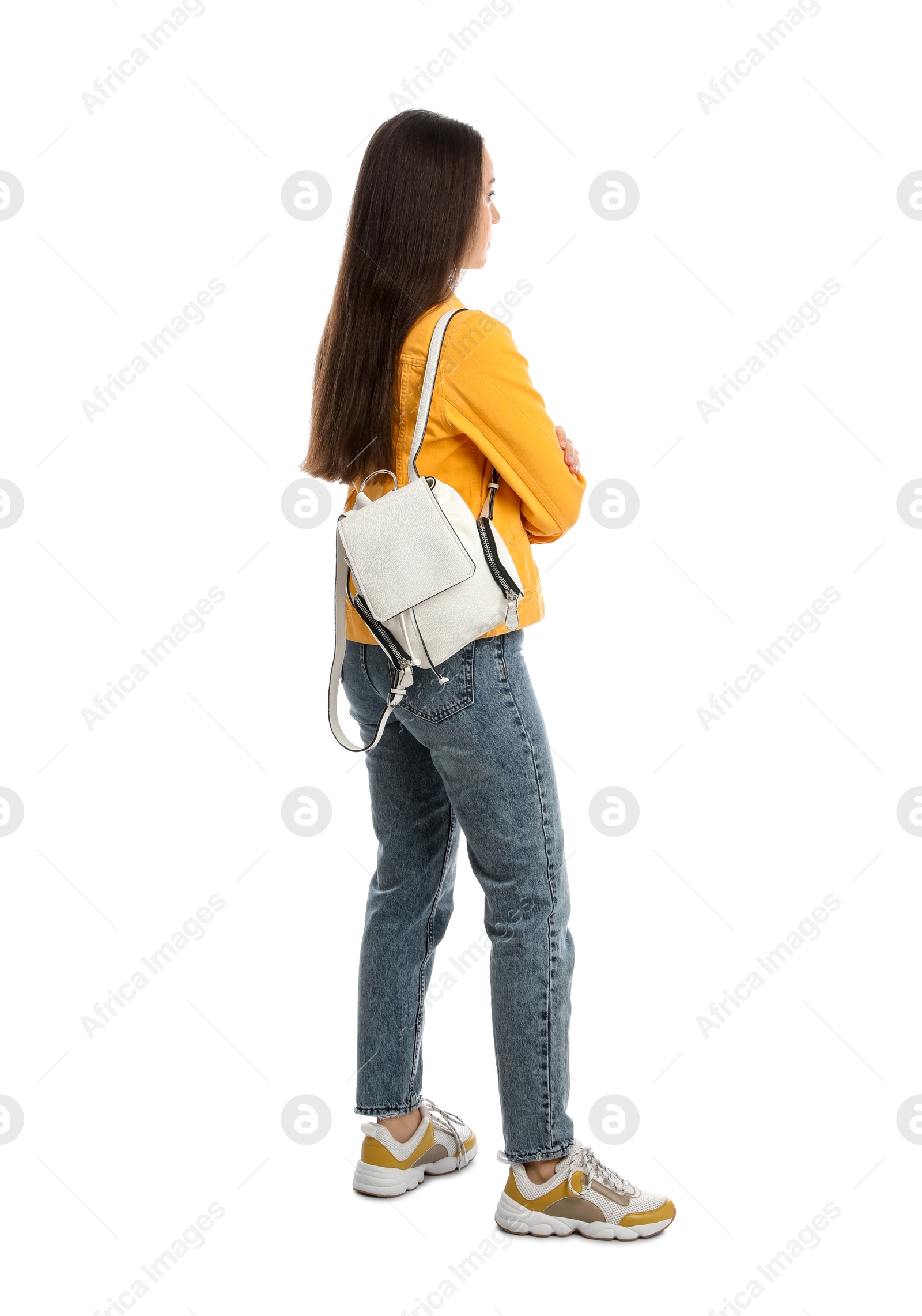 Photo of Young woman in casual clothes with backpack on white background, back view