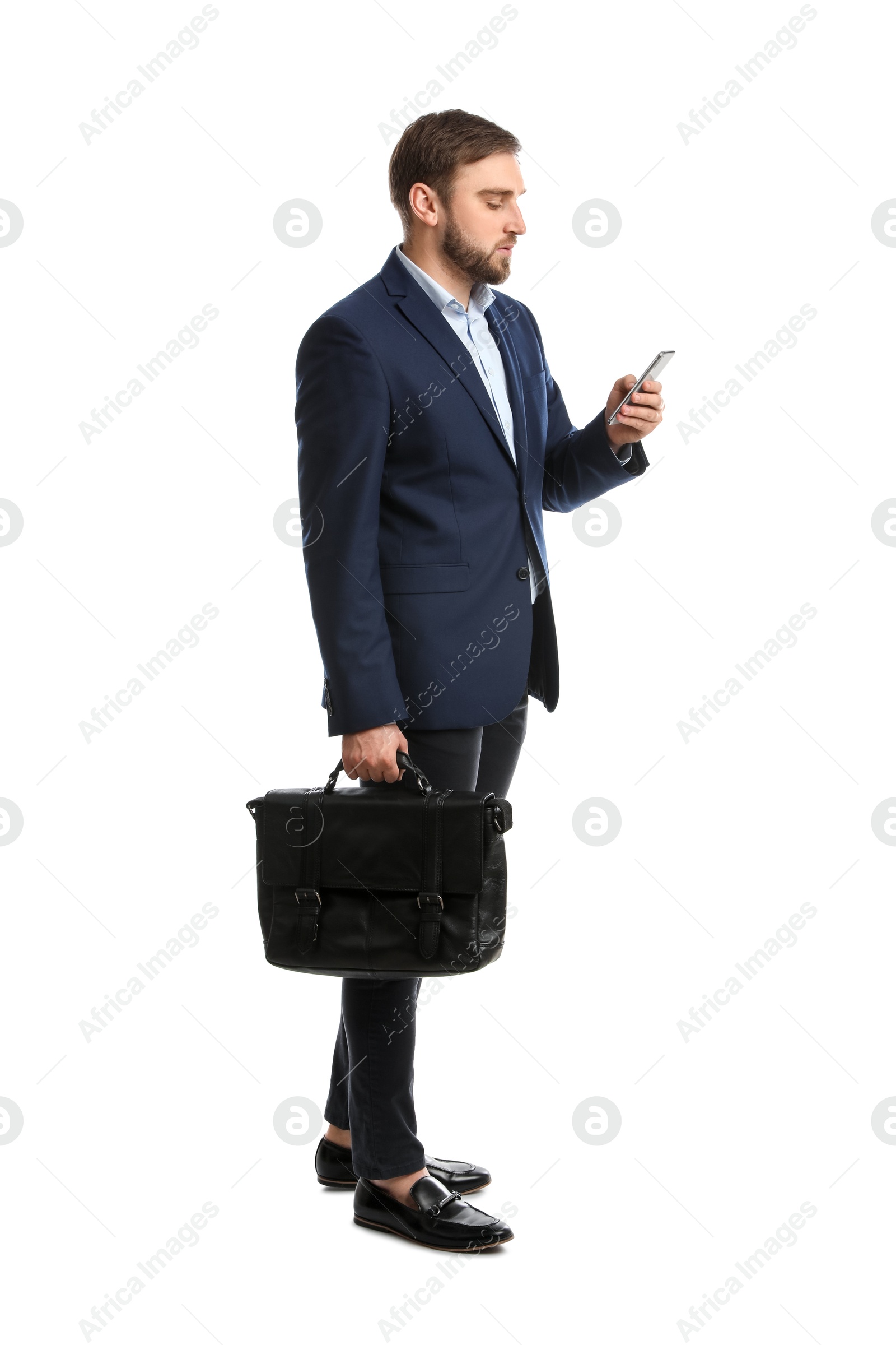 Photo of Young man in business attire with bag and mobile phone on white background