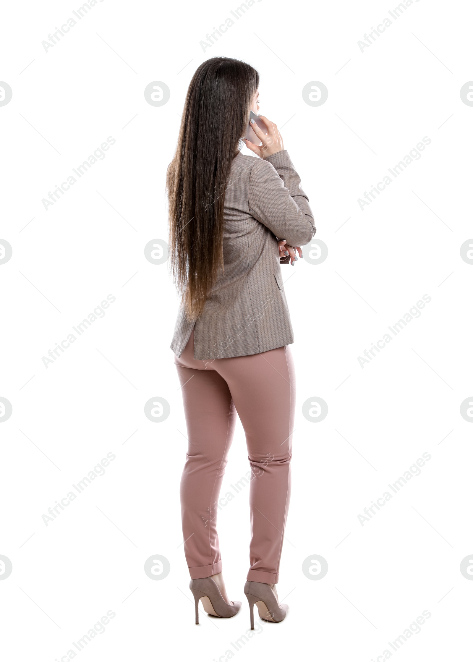 Photo of Young woman in business attire using mobile phone on white background, back view