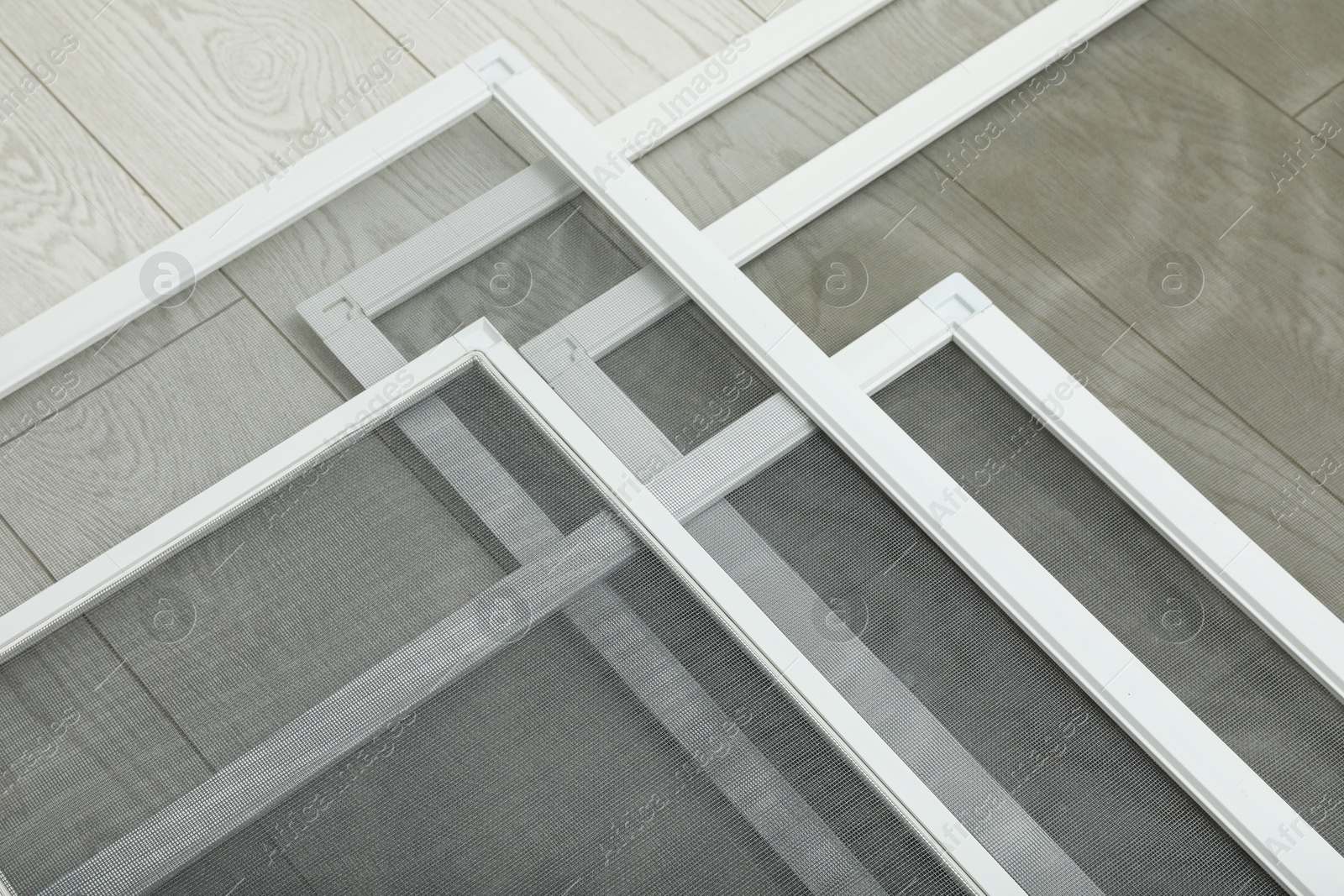 Photo of Set of window screens on wooden floor, closeup