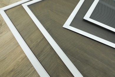 Photo of Set of window screens on wooden floor, above view