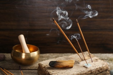 Aromatic incense sticks smoldering on wooden table