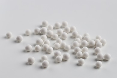 Photo of Homeopathic remedy. Many round pills on white background