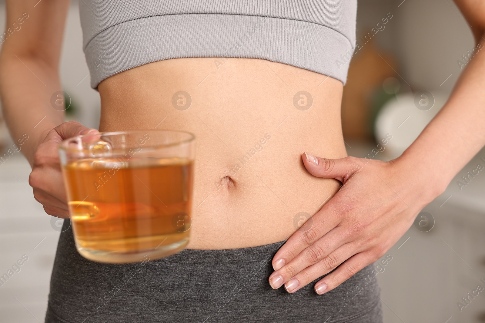 Photo of Weight loss concept. Woman with cup of diet tea indoors, closeup