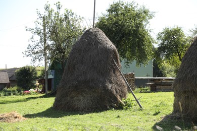 Pile of hay on farmland on sunny day