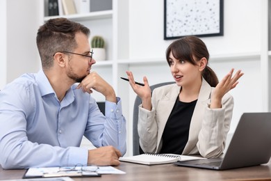 Consultant working with client at table in office. Business meeting