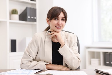 Photo of Portrait of smiling business consultant at table in office