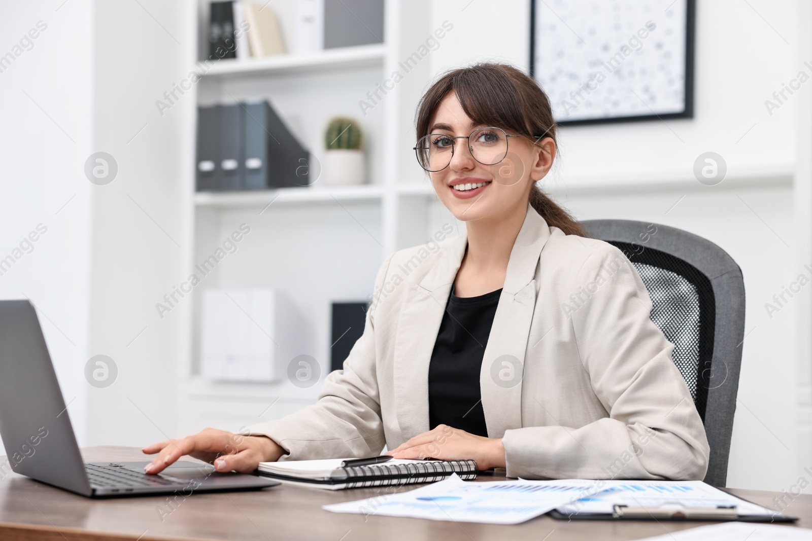 Photo of Portrait of smiling business consultant at table in office