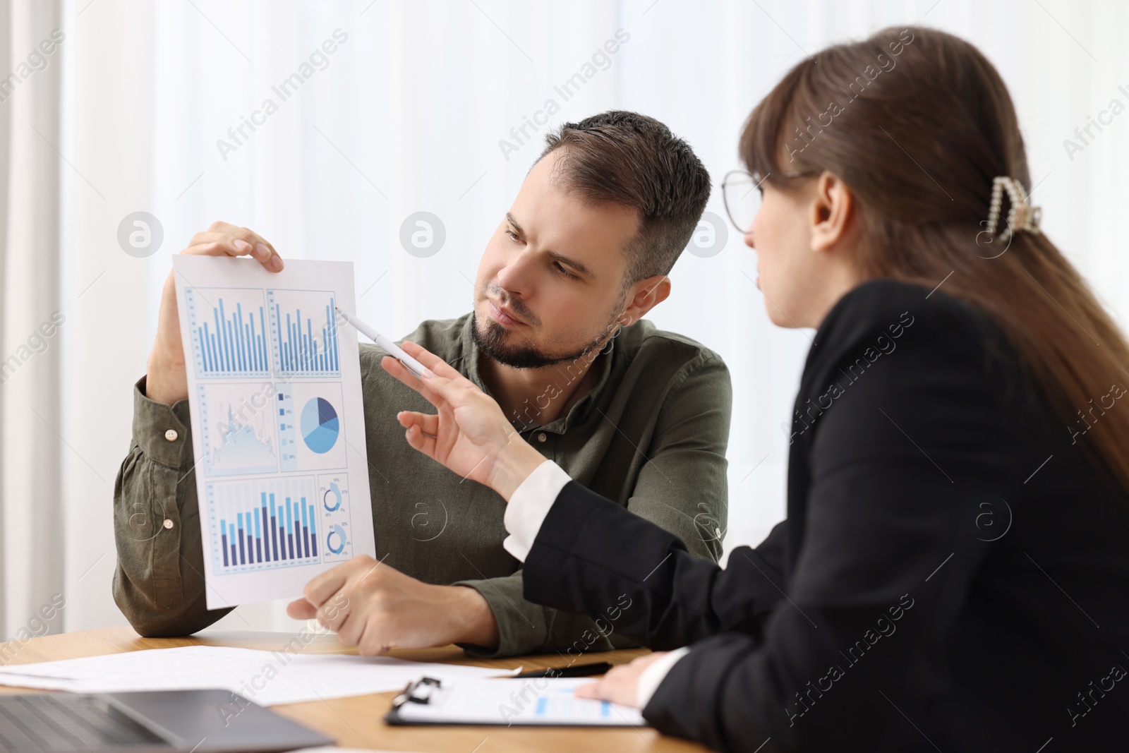 Photo of Consultant working with partner at table in office. Business meeting