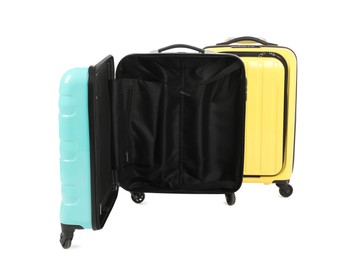 Photo of Two yellow and light blue suitcases isolated on white