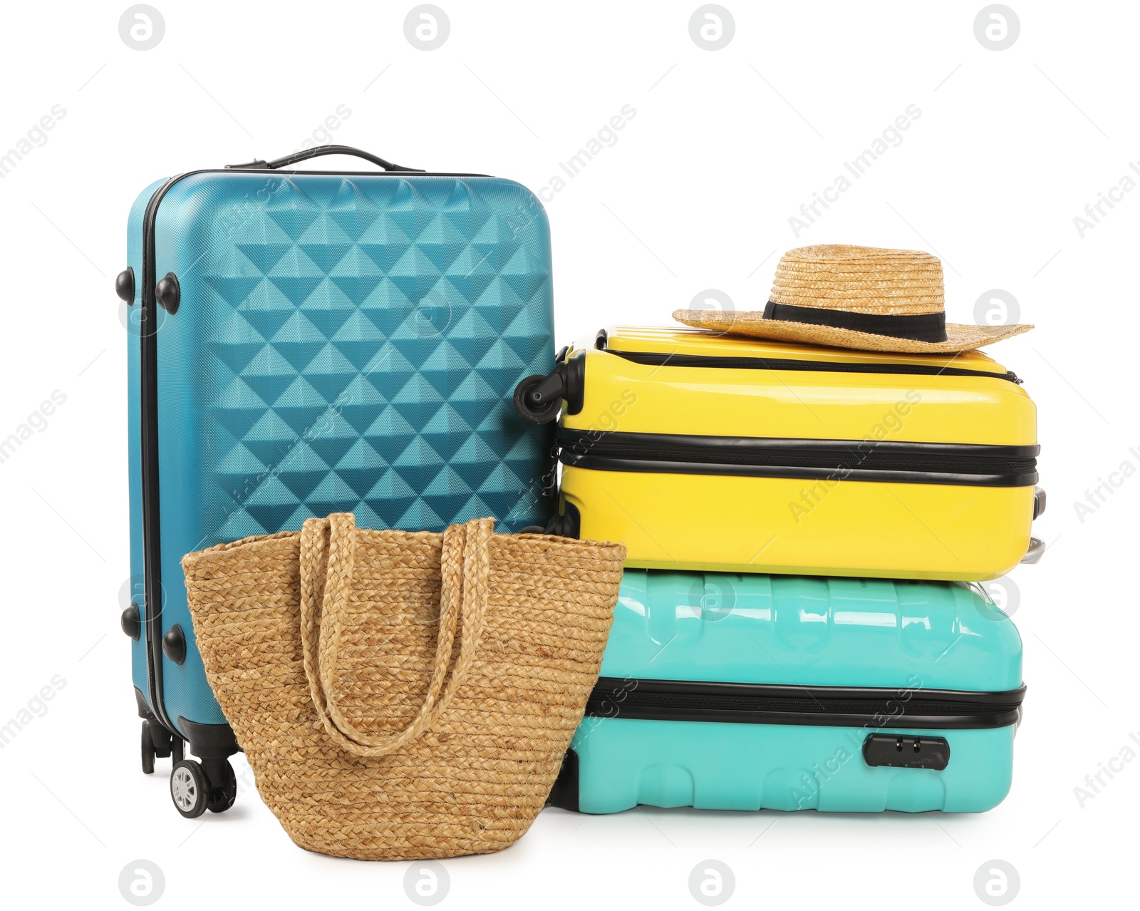 Photo of New suitcases, bag and straw hat isolated on white