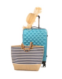 Photo of Light blue suitcase, bag and straw hat isolated on white