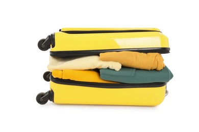 Photo of One new yellow suitcase with clothes isolated on white