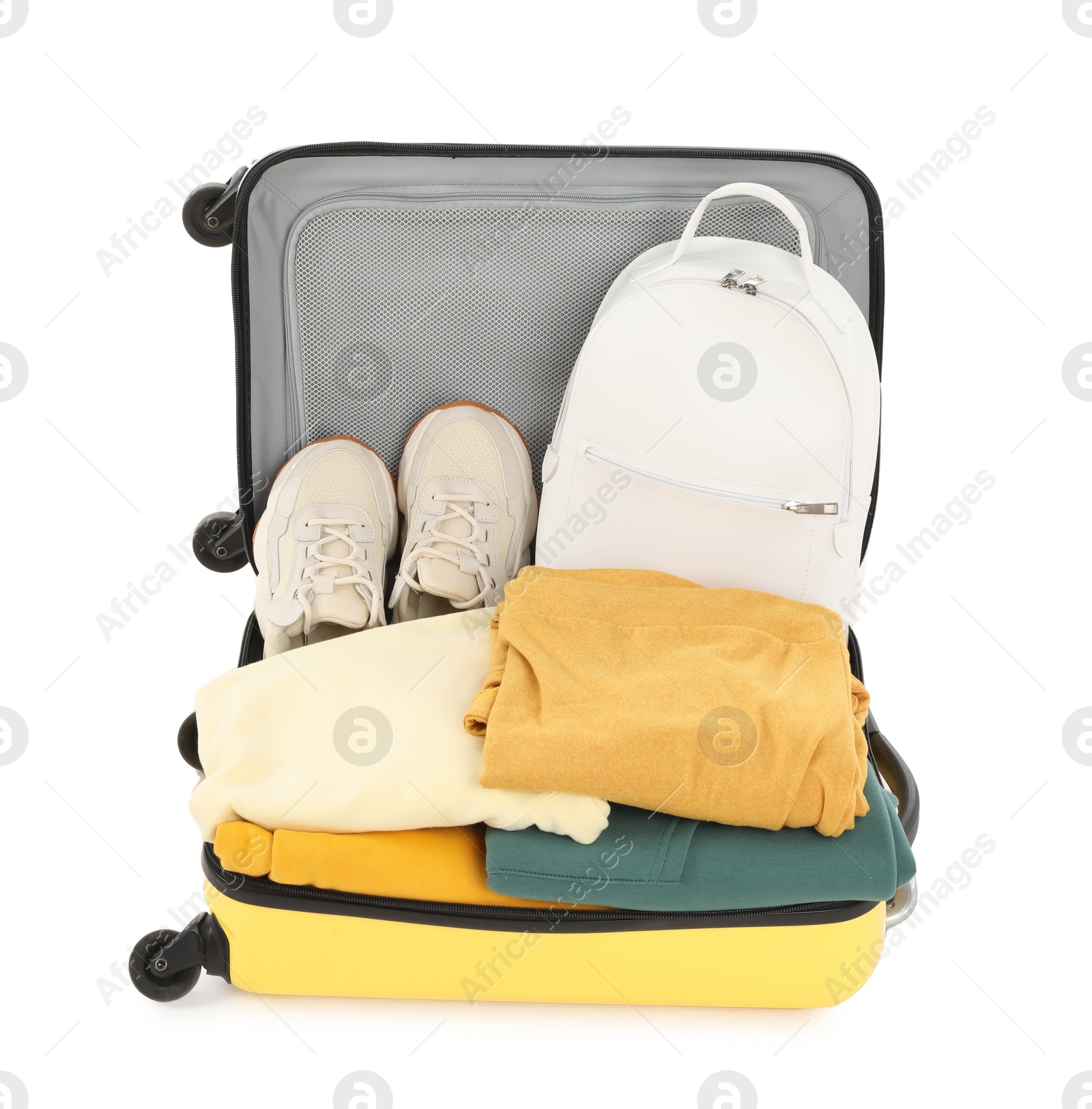 Photo of One new yellow suitcase with personal belongings isolated on white