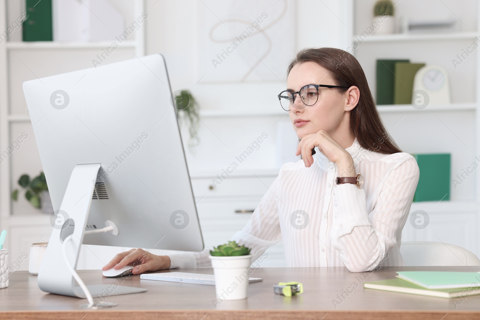 Photo of Beautiful businesswoman working at table in office