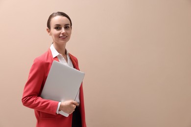 Photo of Portrait of smiling businesswoman with laptop on beige background. Space for text