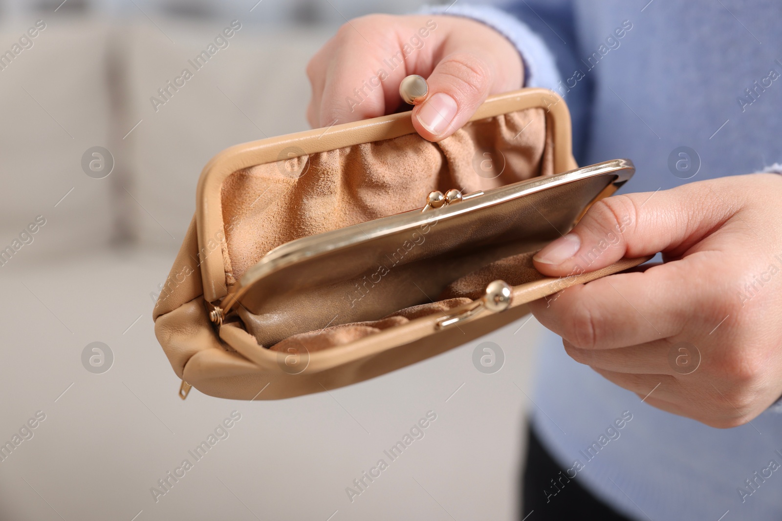 Photo of Woman with empty wallet indoors, closeup view