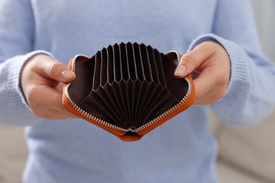 Photo of Woman with empty wallet indoors, closeup view