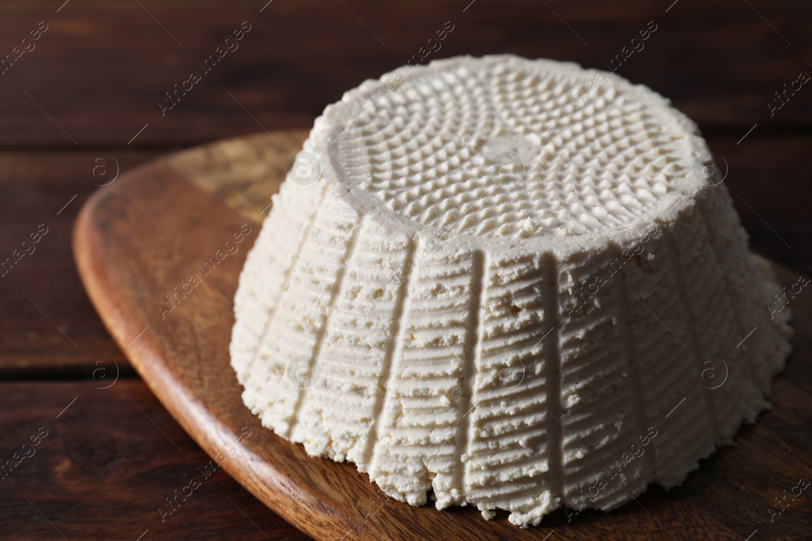 Photo of Tasty ricotta (cream cheese) on wooden table, closeup