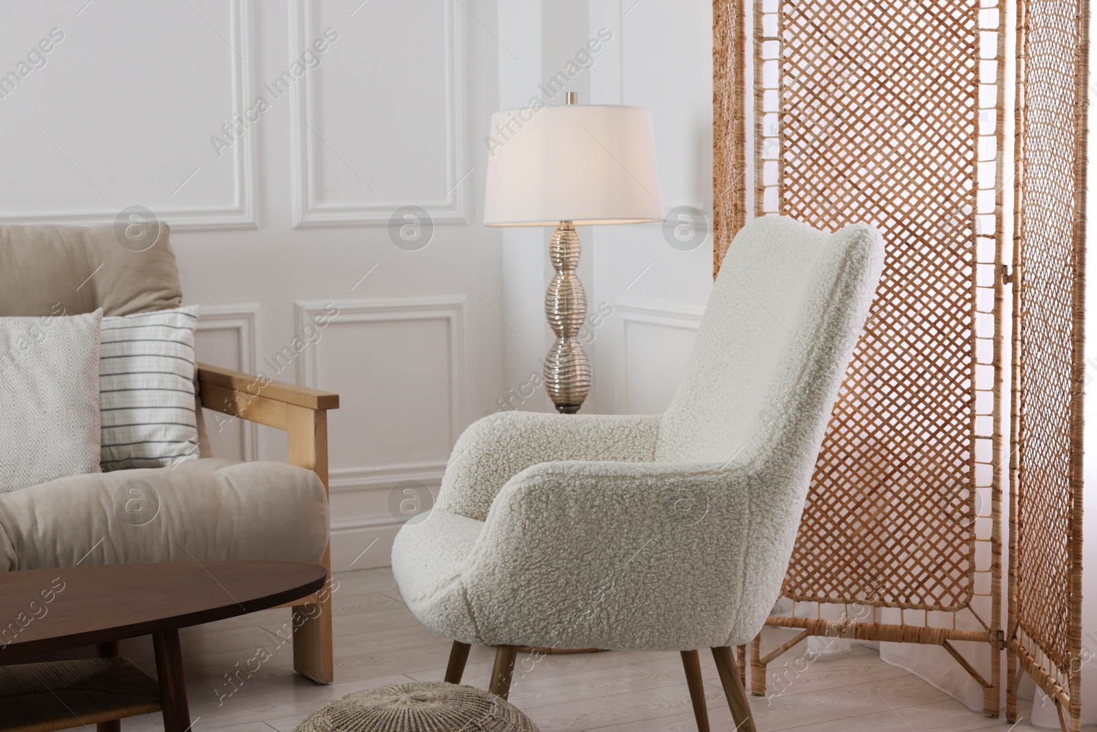 Photo of Folding screen, armchair and lamp in room