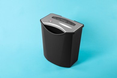 Photo of One paper shredder on light blue background