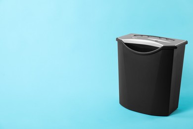 One paper shredder on light blue background, space for text