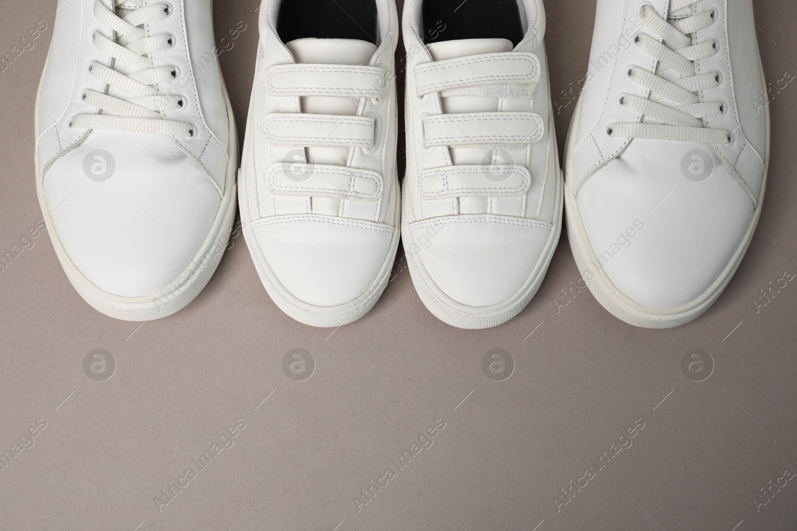 Photo of Big and small shoes on grey background, top view. Space for text