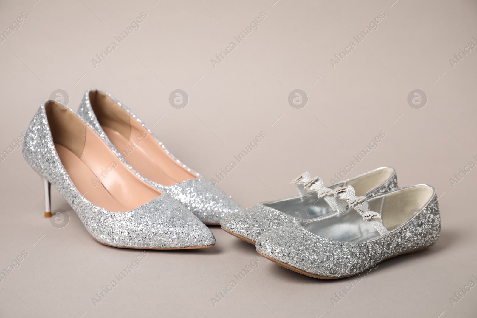 Photo of Big and small shoes on grey background