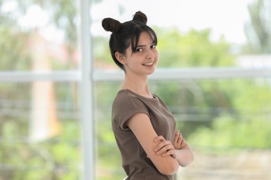 Photo of Portrait of smiling teenage girl on blurred background