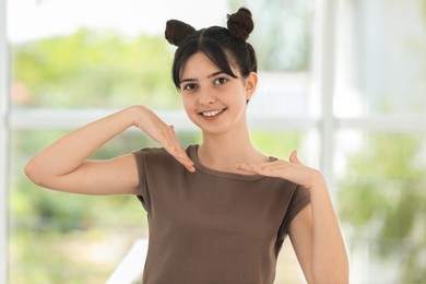 Photo of Portrait of smiling teenage girl on blurred background