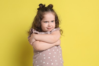 Photo of Portrait of cute girl on yellow background. Adorable child