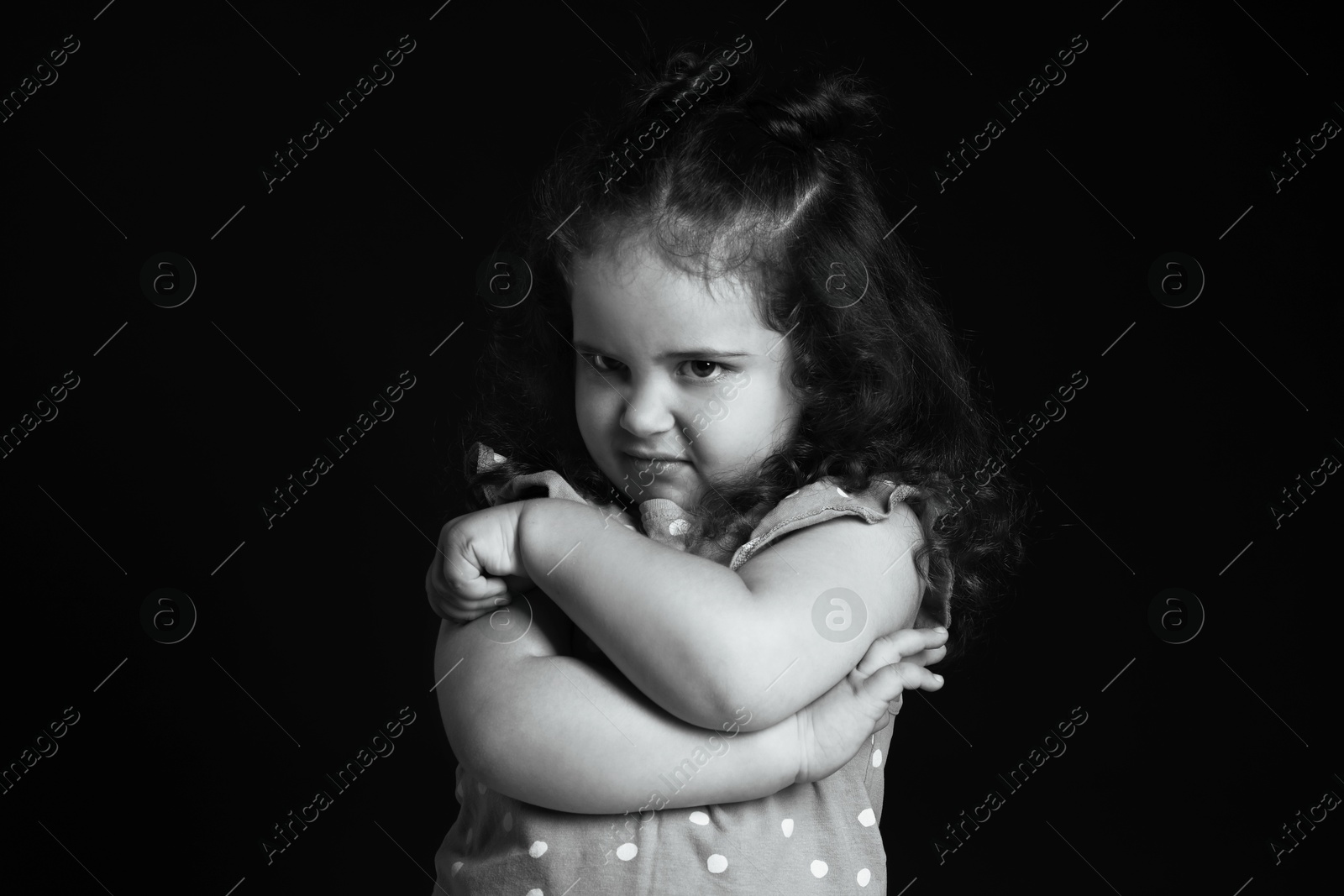 Photo of Portrait of emotional girl on dark background. Black and white effect